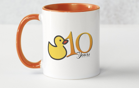 This beautiful dual-tone mug has a vibrant orange handle and interior...